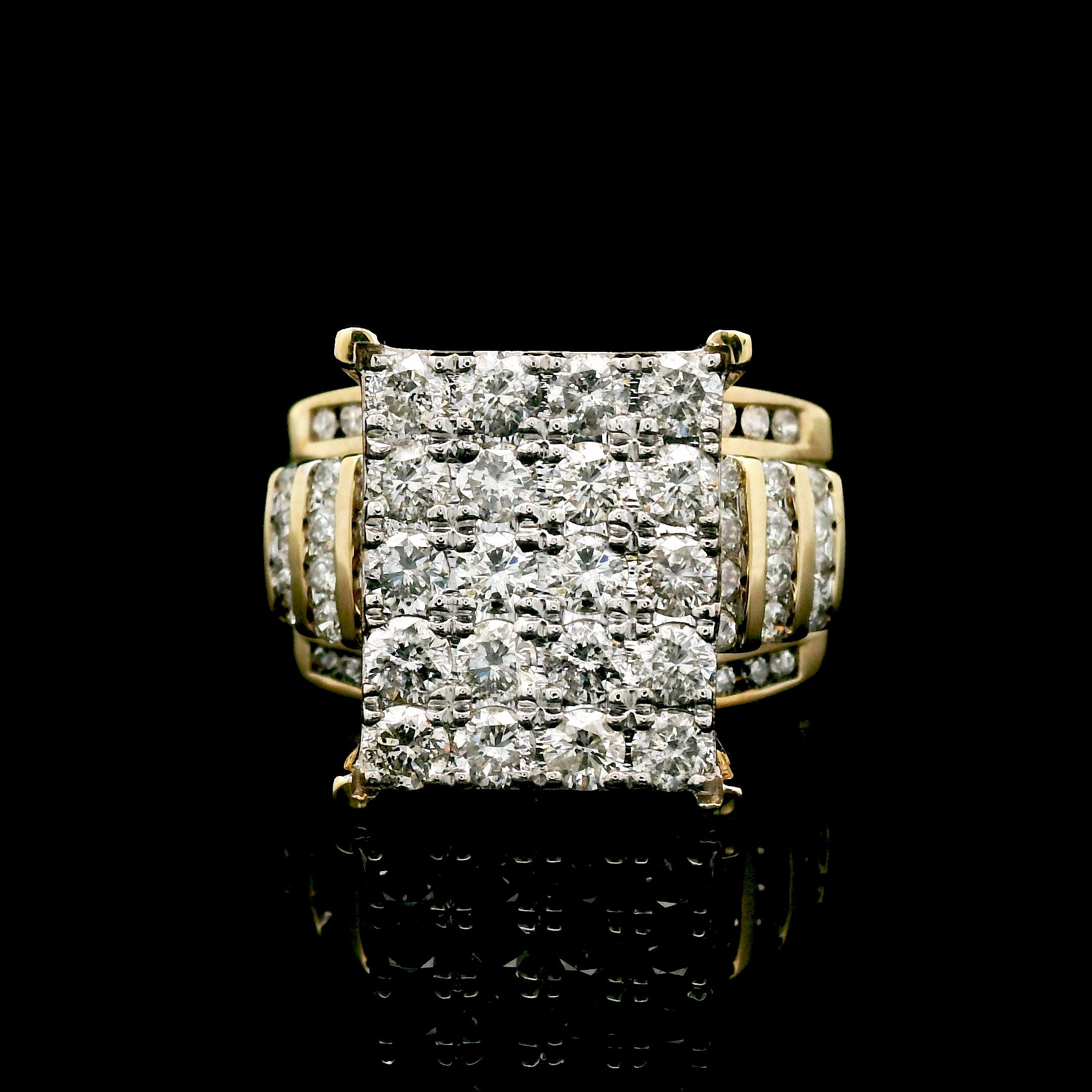 Gold ring with diamond square cluster on a black background